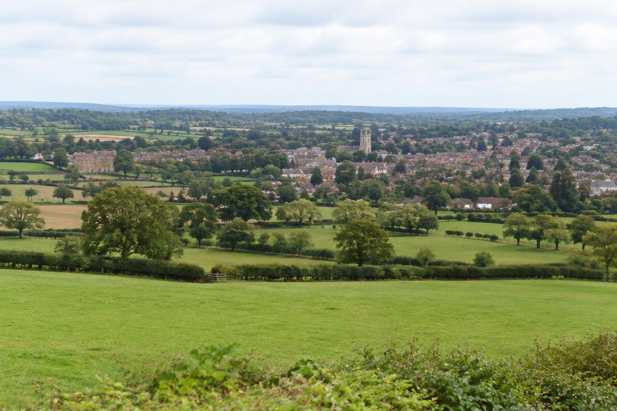 Hertfordshire farmland and hedgerows with a market town in the distance