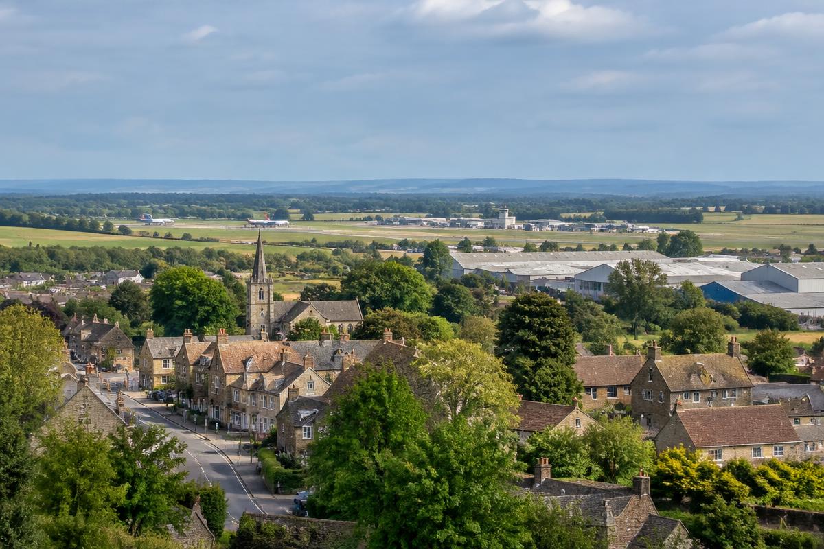 Kidlington and Oxford Airport with village rooftops and light industrial buildings
