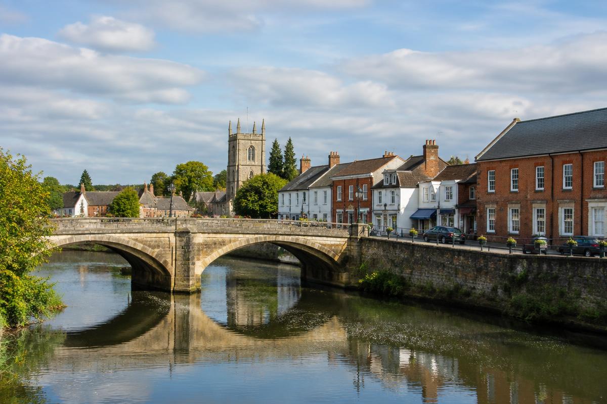 Newport Pagnell historic bridge, church and town buildings beside the river